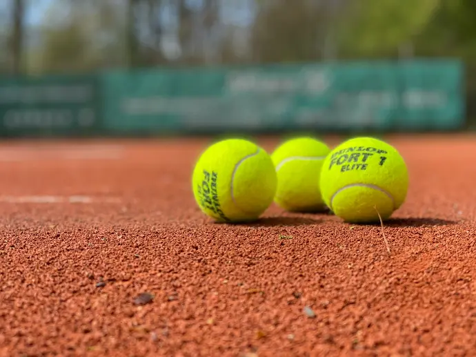 green tennis ball on brown soil